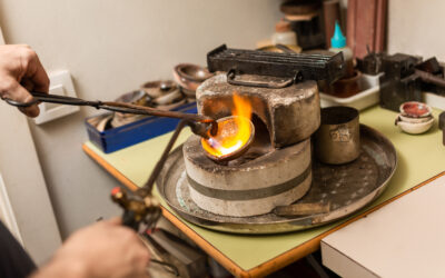 blowtorch melts silver in a jewelry workshop furnace